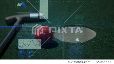 Showing red golf ball resting on putting green, with putter head, putting cup and digital overlays 135086357