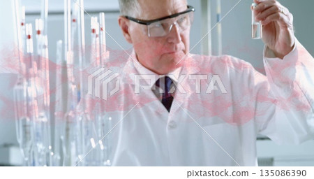 Scientist wearing lab coat and goggles examining test tube in laboratory, with metal test tube rack Scientist wearing lab coat and goggles examining test tube in laboratory, with metal test tube rack 135086390