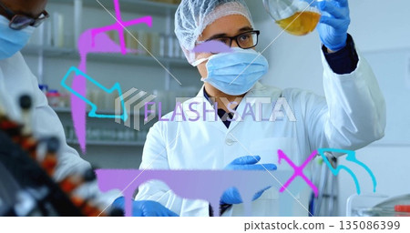 Inspecting male technician in coat holding Erlenmeyer flask with amber solution amid lab reagents 135086399