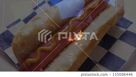 Featuring hot dog resting in bun on checkered liner in concession stand, with mustard and ketchup Featuring hot dog resting in bun on checkered liner in concession stand, with mustard and ketchup 135086446