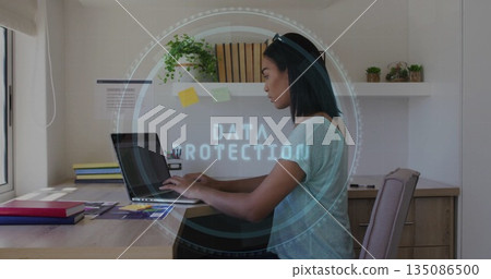 Typing woman wearing gray t-shirt at home office with laptop, data protection overlay, copy space Typing woman wearing gray t-shirt at home office with laptop, data protection overlay, copy space 135086500