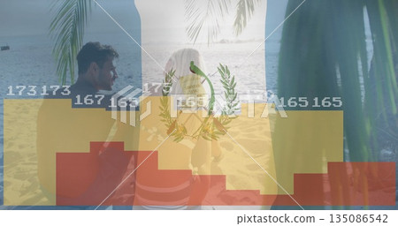 Couple wearing swimwear sitting on sandy beach watching calm ocean horizon under palm fronds shade Couple wearing swimwear sitting on sandy beach watching calm ocean horizon under palm fronds shade 135086542