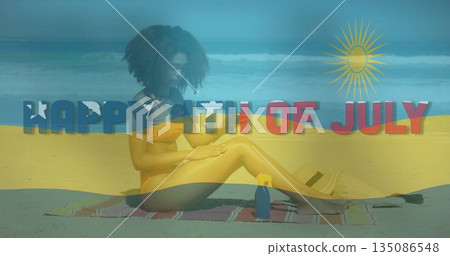 Woman in yellow bikini applying sunscreen to legs on beach shoreline, with blue bottle and sandals 135086548