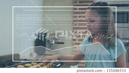 Standing girl arranging raw dough pieces on baking tray at kitchen counter, with digital overlay 135086553