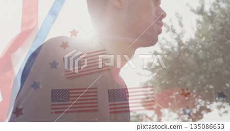 Standing man in sunlight outside, with red blue streamers, flag and star overlays, copy space Standing man in sunlight outside, with red blue streamers, flag and star overlays, copy space 135086653