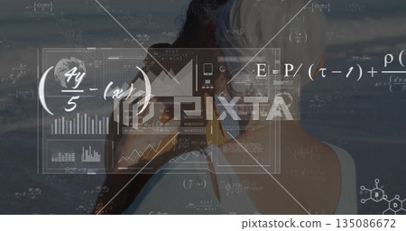 Viewing senior couple examining sea shore data overlay, with binoculars, charts and equations 135086672