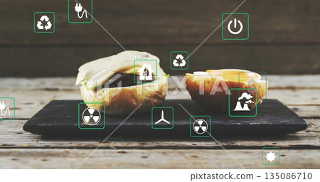 Sitting two slider burgers resting on slate board at wooden table, with floating green energy icons Sitting two slider burgers resting on slate board at wooden table, with floating green energy icons 135086710