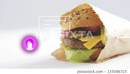 Displaying half-wrapped burger on studio table, with bun, pink icon, translucent UI box, copy space Displaying half-wrapped burger on studio table, with bun, pink icon, translucent UI box, copy space 135086725