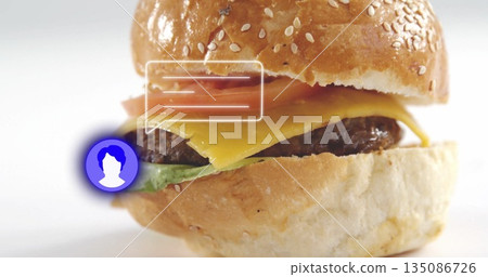 Stacking sesame burger with cheddar, beef patty, lettuce, tomato in studio, with graphic overlays Stacking sesame burger with cheddar, beef patty, lettuce, tomato in studio, with graphic overlays 135086726