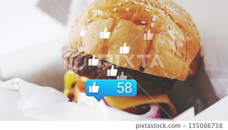 Sitting cheeseburger wrapped in paper on cafe counter with thumbs-up icons and notification bubble 135086738