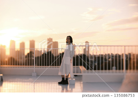 Portrait of a woman on a rooftop at dusk Portrait of a woman on a rooftop at dusk 135086753
