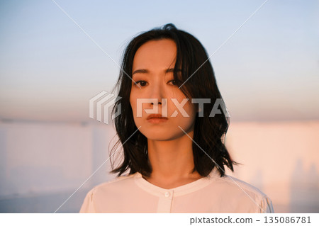 Portrait of a woman on a rooftop at dusk 135086781