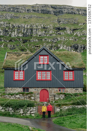 Charming Faroese Village Scene with Grass-Roof Cottages in Kirkjubour, Faroe Islands. High quality photo Charming Faroese Village Scene with Grass-Roof Cottages in Kirkjubour, Faroe Islands. High quality photo 135086782