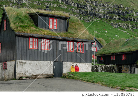 Charming Faroese Village Scene with Grass-Roof Cottages in Kirkjubour, Faroe Islands. High quality photo 135086785