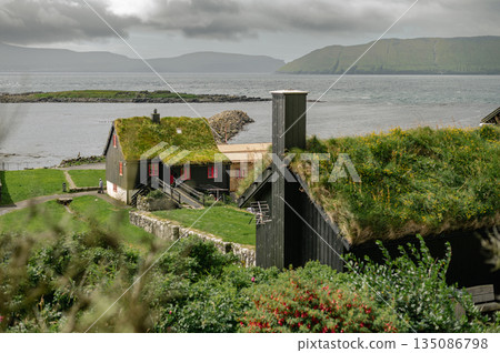 Charming Faroese Village Scene with Grass-Roof Cottages in Kirkjubour, Faroe Islands. High quality photo Charming Faroese Village Scene with Grass-Roof Cottages in Kirkjubour, Faroe Islands. High quality photo 135086798