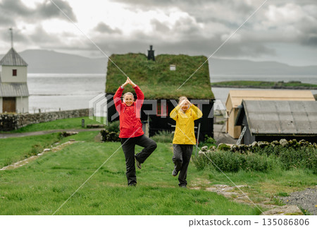 Charming Faroese Village Scene with Grass-Roof Cottages in Kirkjubour, Faroe Islands. High quality photo Charming Faroese Village Scene with Grass-Roof Cottages in Kirkjubour, Faroe Islands. High quality photo 135086806