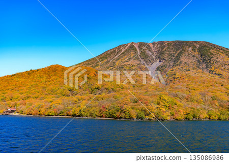 Lake Chuzenji in autumn, Nikko City, Tochigi Prefecture (Mount Nantai seen from a sightseeing boat) 135086986