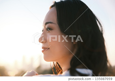 Portrait of a woman on a rooftop at dusk 135087059