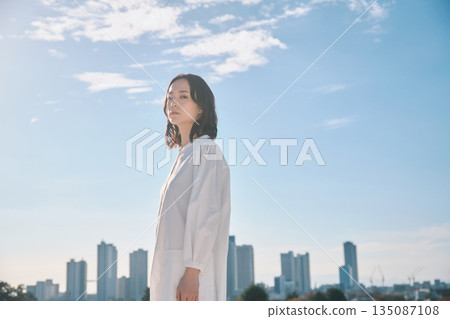 Urban streetscape and young woman 135087108