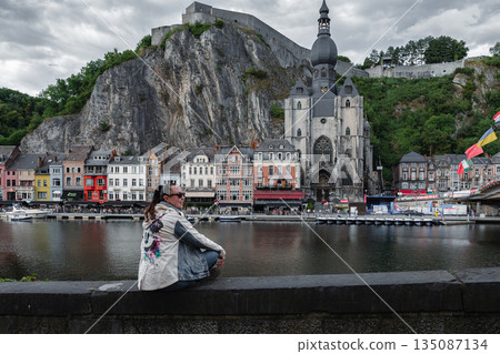 Scenic view of Dinant, Belgium, featuring historic riverside buildings and the citadel perched above the Meuse River. 135087134