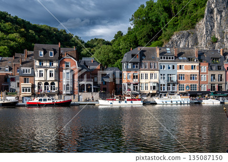 Scenic view of Dinant, Belgium, featuring historic riverside buildings and the citadel perched above the Meuse River. 135087150