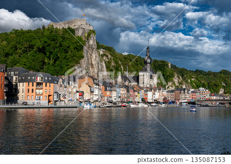 Scenic view of Dinant, Belgium, featuring historic riverside buildings and the citadel perched above the Meuse River. 135087153