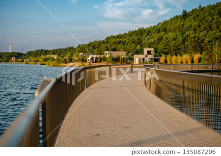 Aerial view of Terhills blue lagoon, green hills, and bike lane tracing the former Eisden coal mine site in Belgium. Aerial view of Terhills blue lagoon, green hills, and bike lane tracing the former Eisden coal mine site in Belgium. 135087206