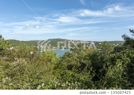 The promenade along Lake Abrau-Dyurso with calm water, greenery, and scenic surroundings The promenade along Lake Abrau-Dyurso with calm water, greenery, and scenic surroundings 135087425