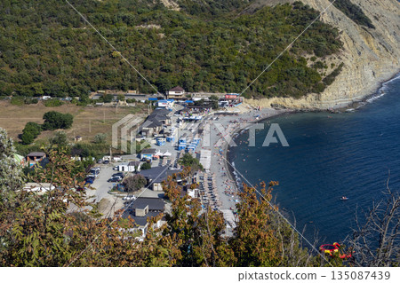 Scenic view of Durso beach with clear sea and mountain landscape, showcasing natural coastline, summer atmosphere and peaceful seaside environment in southern Russia Scenic view of Durso beach with clear sea and mountain landscape, showcasing natural coastline, summer atmosphere and peaceful seaside environment in southern Russia 135087439
