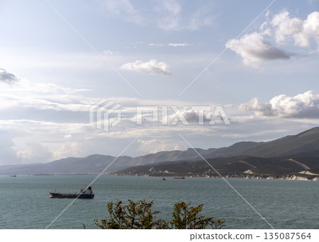 Wild beach on the coast of Kabardinka village, Russia, with cliffs, trees and natural scenery, showcasing untouched coastal landscape and seaside environment 135087564