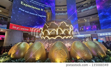 this is snake sculpture coils around golden eggs with Chinese calligraphy this is snake sculpture coils around golden eggs with Chinese calligraphy 135088349