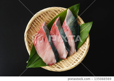 Yellowtail fillets served on a colander (Hanaran, black background) 135088569