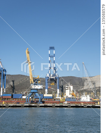 August 22 2025 View of Novorossiysk port Russia with cargo ships and cranes on the coastline. Industrial maritime scene on the Black Sea August 22 2025 View of Novorossiysk port Russia with cargo ships and cranes on the coastline. Industrial maritime scene on the Black Sea 135088579