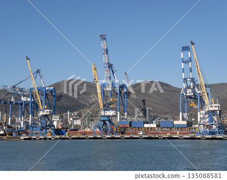 August 22 2025 View of Novorossiysk port Russia with cargo ships and cranes on the coastline. Industrial maritime scene on the Black Sea August 22 2025 View of Novorossiysk port Russia with cargo ships and cranes on the coastline. Industrial maritime scene on the Black Sea 135088581