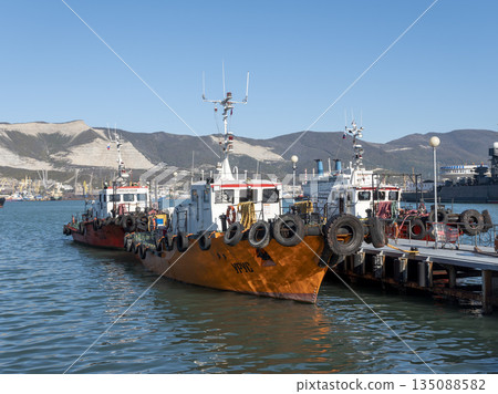 August 22 2025 Orange work boat Urus moored at the pier in Novorossiysk Russia on the Black Sea coast. Small harbor vessel at the quay August 22 2025 Orange work boat Urus moored at the pier in Novorossiysk Russia on the Black Sea coast. Small harbor vessel at the quay 135088582