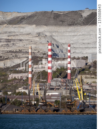 August 22 2025 View of Novorossiysk port Russia with cargo ships and cranes on the coastline. Industrial maritime scene on the Black Sea August 22 2025 View of Novorossiysk port Russia with cargo ships and cranes on the coastline. Industrial maritime scene on the Black Sea 135088643