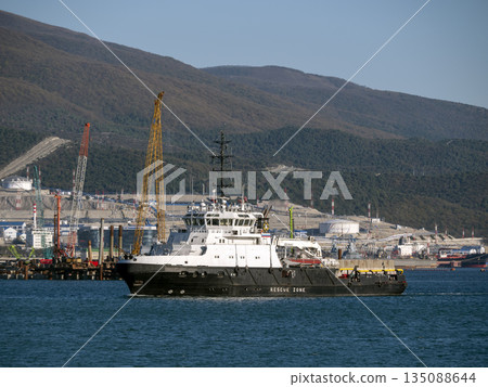 August 22 2025 View of Novorossiysk port Russia with cargo ships and cranes on the coastline. Industrial maritime scene on the Black Sea August 22 2025 View of Novorossiysk port Russia with cargo ships and cranes on the coastline. Industrial maritime scene on the Black Sea 135088644