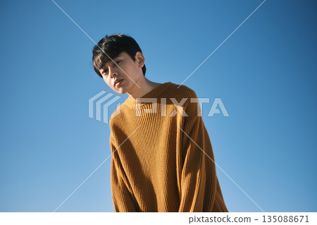 Portrait of a man with a blue sky background Portrait of a man with a blue sky background 135088671