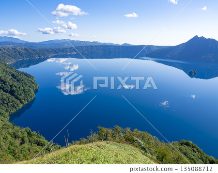 Lake Mashu's mirror-like surface in the morning, seen from the third observation deck in late September Lake Mashu's mirror-like surface in the morning, seen from the third observation deck in late September 135088712
