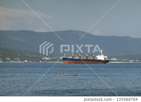 August 24, 2025: Large cargo ship entering the port of Novorossiysk, Russia, on the Black Sea, illustrating maritime transport, industrial shipping and coastal infrastructure 135088784