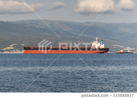 August 24, 2025: Large cargo ship entering the port of Novorossiysk, Russia, on the Black Sea, illustrating maritime transport, industrial shipping and coastal infrastructure August 24, 2025: Large cargo ship entering the port of Novorossiysk, Russia, on the Black Sea, illustrating maritime transport, industrial shipping and coastal infrastructure 135088817