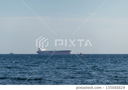 August 24, 2025: Large cargo ship entering the port of Novorossiysk, Russia, on the Black Sea, illustrating maritime transport, industrial shipping and coastal infrastructure 135088829