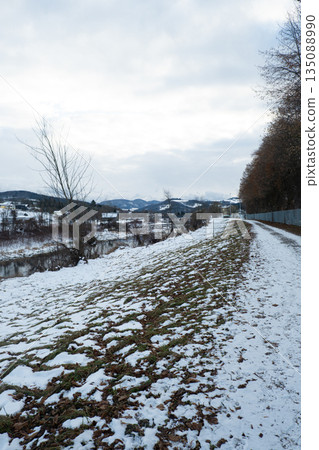 Vertical view of snowy path along river in winter Vertical view of snowy path along river in winter 135088990