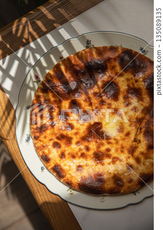Megrelian khachapuri with baked cheese crust on plate Megrelian khachapuri with baked cheese crust on plate 135089135