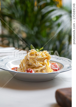 Creamy pasta with cherry tomatoes and herbs Creamy pasta with cherry tomatoes and herbs 135089148