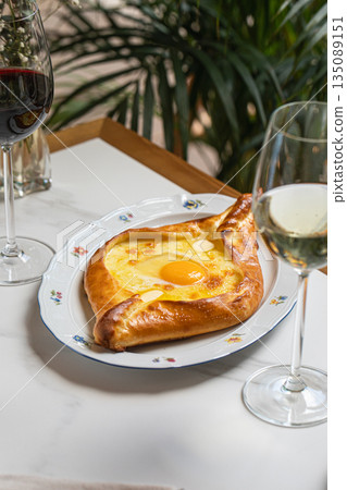 Adjarian khachapuri with egg and cheese Adjarian khachapuri with egg and cheese 135089151