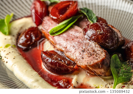 Roasted duck breast with plum sauce and creamy puree Roasted duck breast with plum sauce and creamy puree 135089432