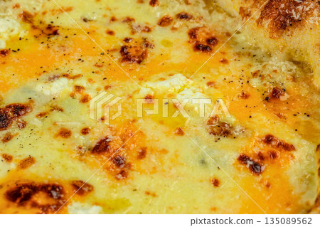 Close-up of Italian four cheese pizza with melted golden crust and seasoning 135089562