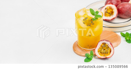 Fresh passion fruit juice with ice and mint on white background. Long banner format. copy space Fresh passion fruit juice with ice and mint on white background. Long banner format. copy space 135089566