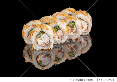 Sushi rolls filled with shrimp, cream cheese, cucumber, and crunchy toppings are neatly arranged and reflected on a glossy black surface Sushi rolls filled with shrimp, cream cheese, cucumber, and crunchy toppings are neatly arranged and reflected on a glossy black surface 135089693